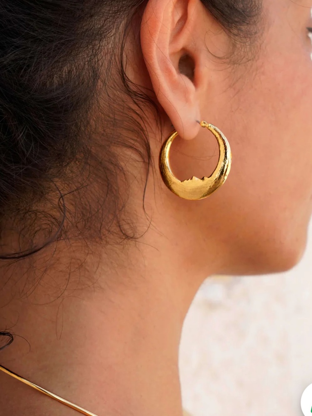 Gold Luna earrings with face silhouette En Route